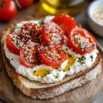 Ricotta & Tomato Toast with Sesame Seeds & Olive Oil 5 inesboulila A slice of crispy golden brown toast topped with a 581e0a9c 9a66 4e70 9551 0897f7938ef1