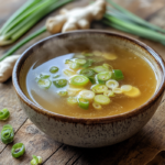 Scallion Ginger Bone Broth: A Hearty and Healing Drink 5 inesboulila A steaming bowl of golden collagen rich bone broth 07a77bf4 5b93 4950 9dac 33fe0fe1349d 1