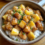 Pineapple Chicken and Rice: A Tropical Taste Sensation 5 inesboulila A rustic ceramic bowl filled with golden browned ch b0824873 2976 40df 9ba7 986498ac81e0