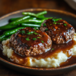 Salisbury Steak with Brown Gravy – Savory, Classic Comfort Food 3 inesboulila A rustic ceramic plate featuring two juicy Salisbur aca68eb4 1b94 443f 9f34 d219ca661eb0