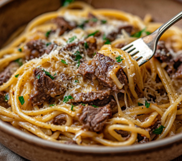 inesboulila A steaming bowl of Delicious Garlic Beef Pasta serv 5ecd143a 5abb 49fb b9b9 265c0a2384ac
